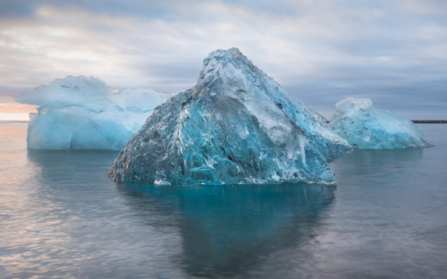 Large iceberg ocean cloudy sky free wallpaper for desktop - medium preview image