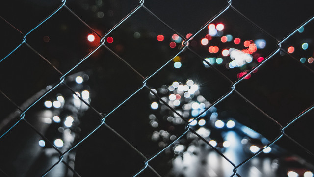 Blurry city street night chainlink free wallpaper for desktop - medium preview image