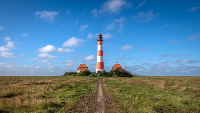 Lighthouse grassy field dirt path free wallpaper for desktop - medium preview image