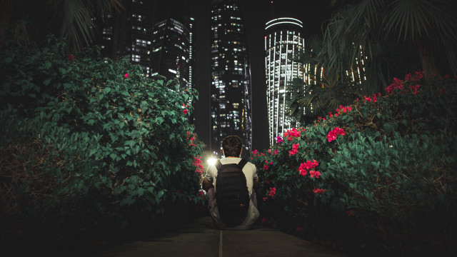 Night cityscape man walking backpack free wallpaper for desktop - medium preview image