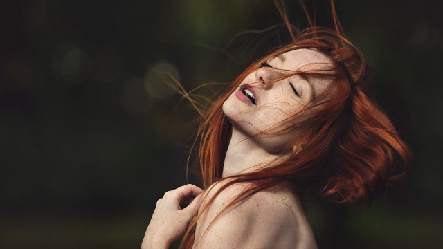 Red haired woman smiling blowing free wallpaper for desktop - medium preview image