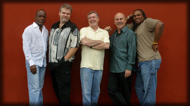 Men group red wall smiling free wallpaper for desktop - medium preview image