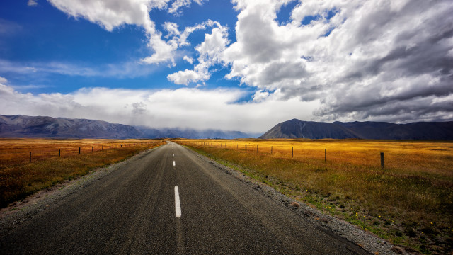 Long road fence mountains cloudy free wallpaper for desktop - medium preview image
