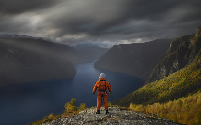 Man orange suit cliff lake free wallpaper for desktop - medium preview image