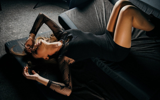 Woman black couch crossed legs free wallpaper for desktop - medium preview image