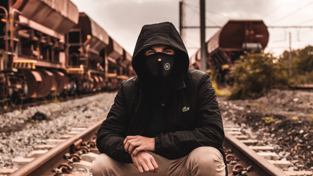 Man black hoodie train track free wallpaper for desktop - medium preview image