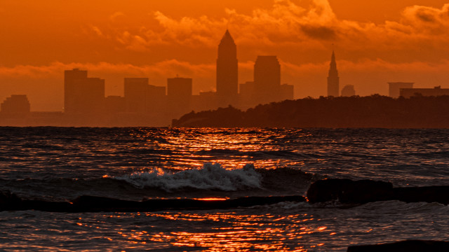 City skyline ocean sunset waves free wallpaper for desktop - medium preview image
