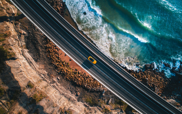 Ocean road yellow car cinematic free wallpaper for desktop - medium preview image
