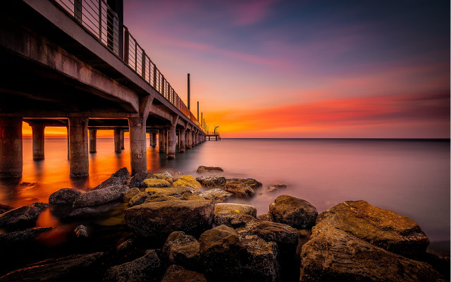 Pier sunset rocks water cityscape free wallpaper for desktop - medium preview image