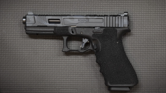 Black gun on table realistic free wallpaper for desktop - medium preview image