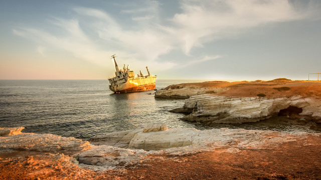 Large boat rocky shore cliff free wallpaper for desktop - medium preview image