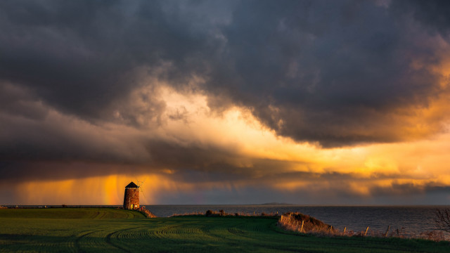 Lighthouse field stormy sky ocean free wallpaper for desktop - medium preview image