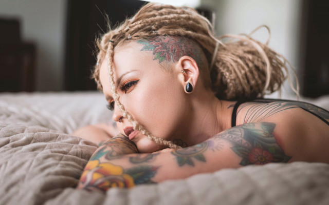 Tattooed woman bed blonde blurry free wallpaper for desktop - medium preview image