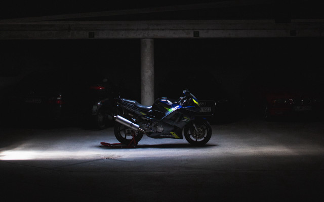 Motorcycle parking garage night minimalist free wallpaper for desktop - medium preview image