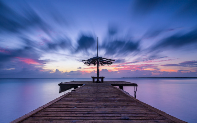 Pier umbrella person sunset clouds free wallpaper for desktop - medium preview image