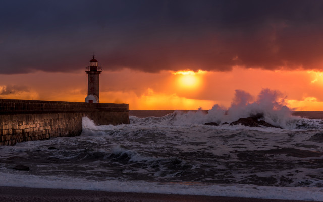 Lighthouse wave sunset stormy beach free wallpaper for desktop - medium preview image