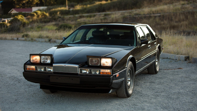 Black car gravel road hill free wallpaper for desktop - medium preview image