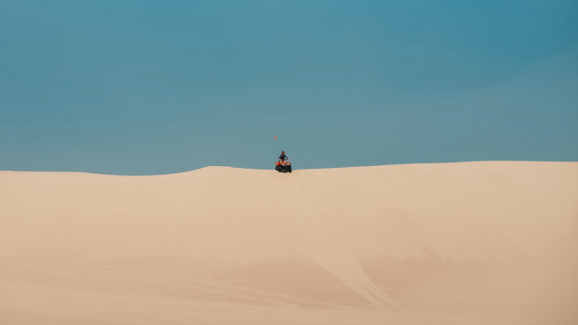 Desert quad rider blue sky free wallpaper for desktop - medium preview image