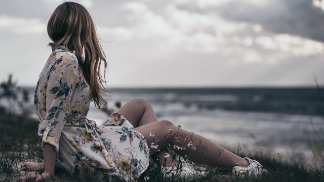 Woman sitting grass looking water free wallpaper for desktop - medium preview image