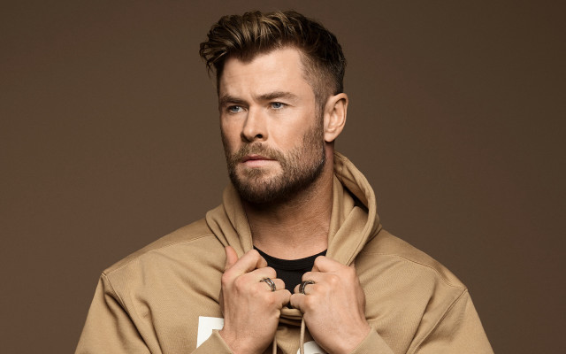 Man in brown hoodie tying free wallpaper for desktop - medium preview image