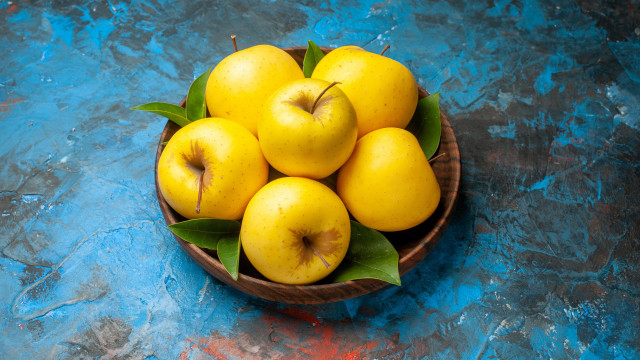 Yellow apples bowl blue surface free wallpaper for desktop - medium preview image