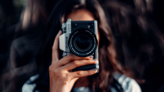 Woman camera blowing hair art free wallpaper for desktop - medium preview image