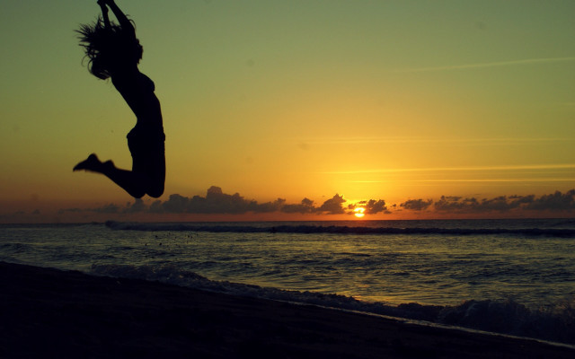 Beach sunset jumping figure ocean free wallpaper for desktop - medium preview image