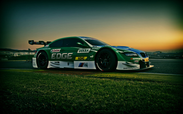Green race car sunset tiltshift free wallpaper for desktop - medium preview image