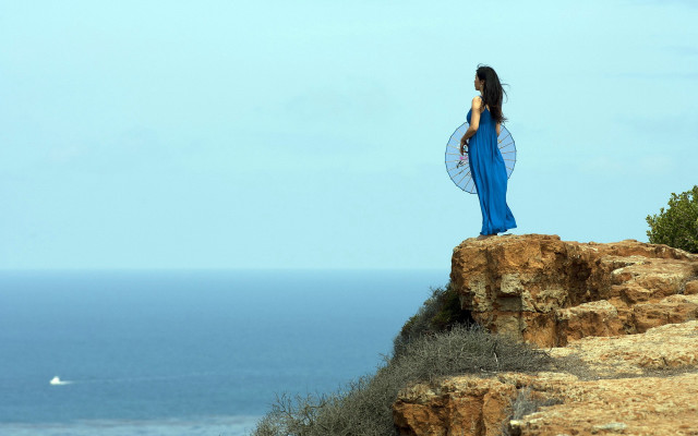 Woman blue dress cliff ocean free wallpaper for desktop - medium preview image