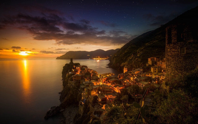 Village cliff overlooking water night free wallpaper for desktop - medium preview image