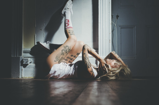 Woman sitting tattooed back legs free wallpaper for desktop - medium preview image