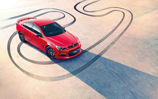 Red car curved road spiral free wallpaper for desktop - medium preview image