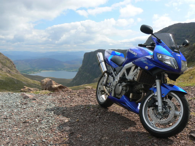 Blue motorcycle lake hill mountains free wallpaper for desktop - medium preview image