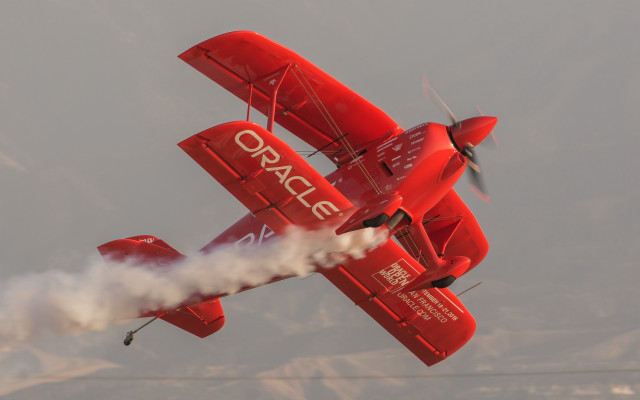 Red plane smoke wings mountains free wallpaper for desktop - medium preview image