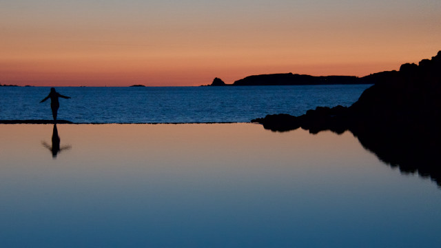 Person rock water sunset surfboard free wallpaper for desktop - medium preview image