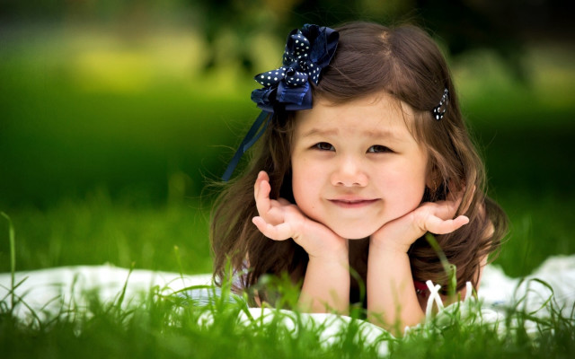 Little girl blanket grass smiling free wallpaper for desktop - medium preview image