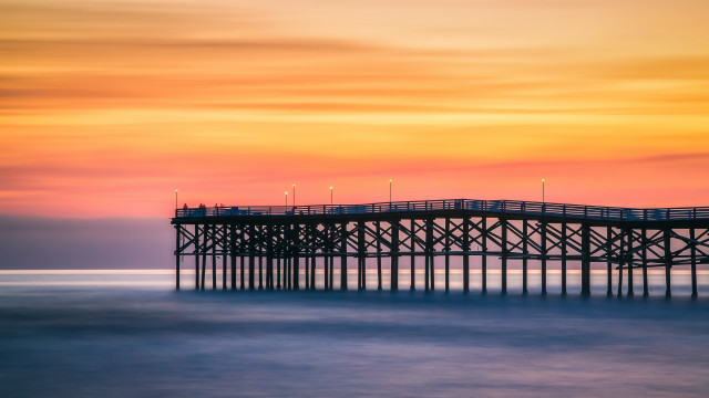 Pier lighthouse sunset ocean colorful free wallpaper for desktop - medium preview image