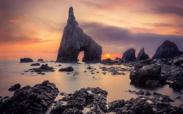 Rock formation sunset ocean clouds free wallpaper for desktop - medium preview image