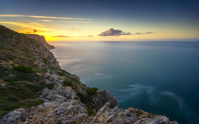 Sunset rocky cliff water mountain free wallpaper for desktop - medium preview image