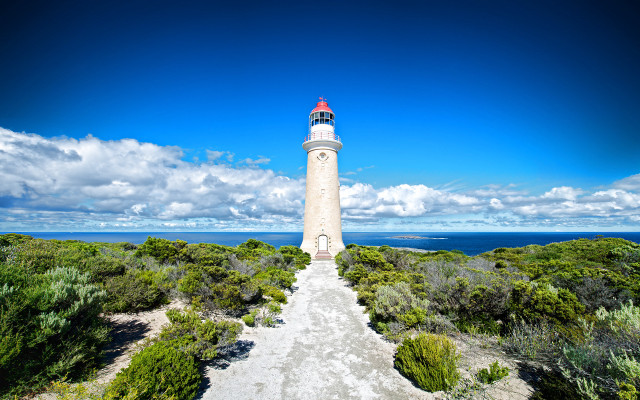 Lighthouse hill blue sky clouds free wallpaper for desktop - medium preview image