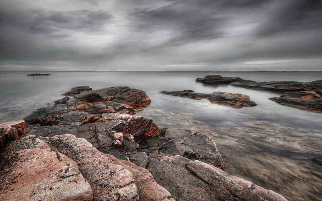 Rocky shore mountainous horizon moody free wallpaper for desktop - medium preview image