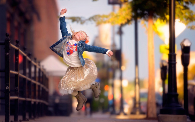Girl jumping autumn blurry bokeh free wallpaper for desktop - medium preview image