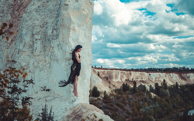 Woman rock ledge mountains sky free wallpaper for desktop - medium preview image
