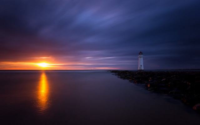 Lighthouse rocky shore sunset orange free wallpaper for desktop - medium preview image