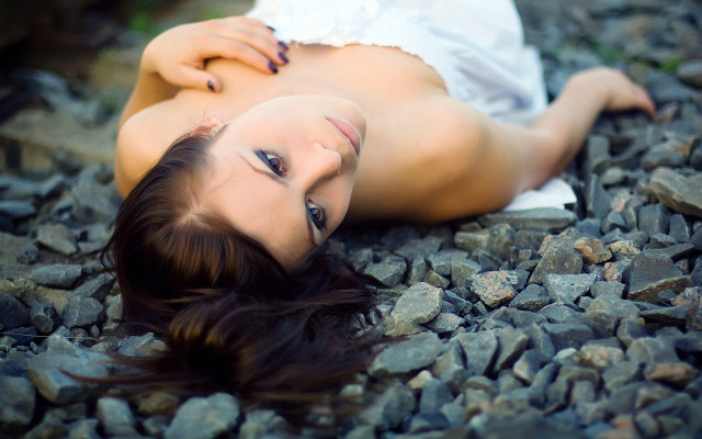 Woman rocks blowing hair portrait free wallpaper for desktop - medium preview image