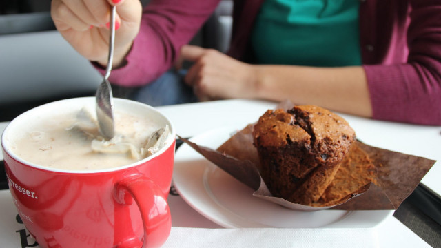 Woman eating muffin coffee table free wallpaper for desktop - medium preview image
