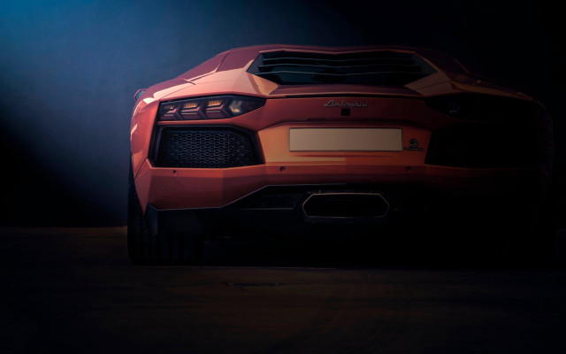 Red sports car dark spotlight free wallpaper for desktop - medium preview image