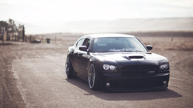 Black car driving road grass #3 free wallpaper for desktop - medium preview image