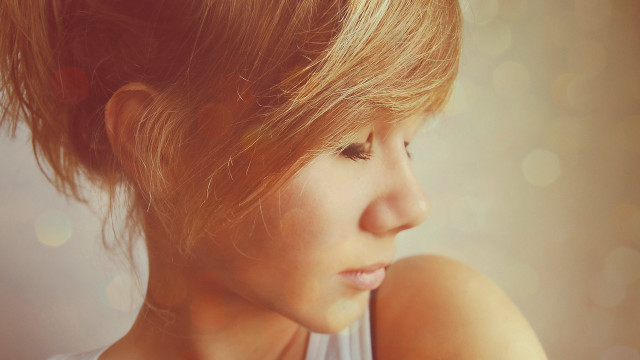 Woman messybun lookingdown closeup realistic free wallpaper for desktop - medium preview image