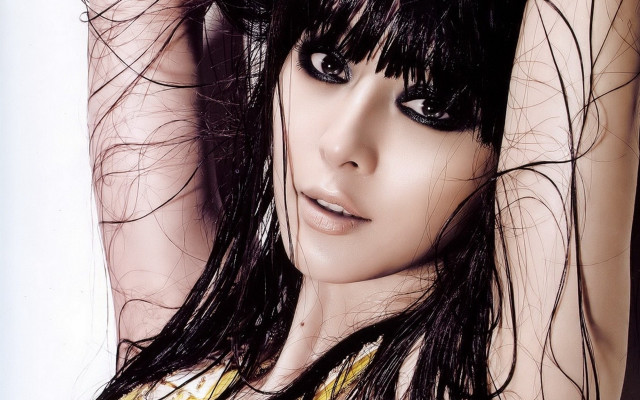 Woman blowing hair black eyes free wallpaper for desktop - medium preview image